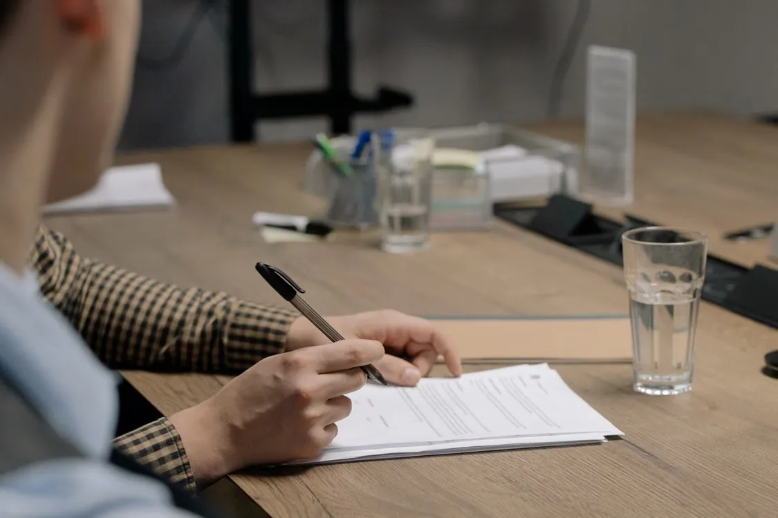 Homeowner reviewing an insurance declarations page with a pen in hand