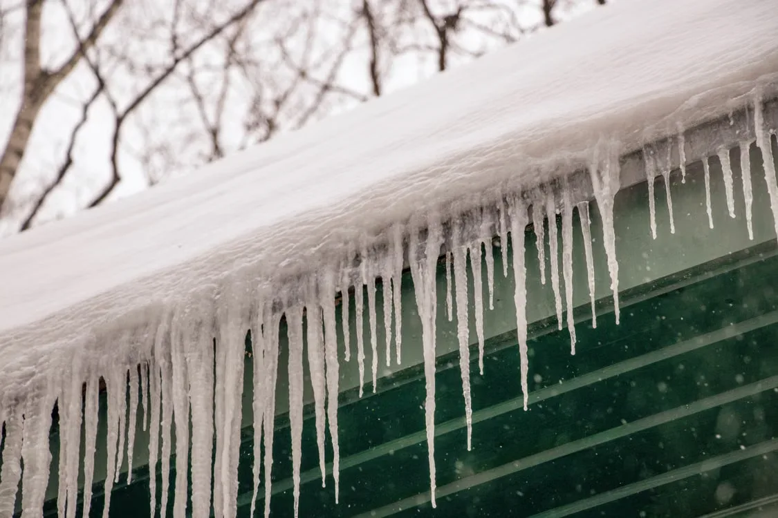 Ice dam and icicles built up along the edge of a Missouri roof